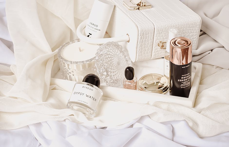 A stylish flat lay of luxury cosmetics and accessories on a white background, perfect for elegance and lifestyle themes.