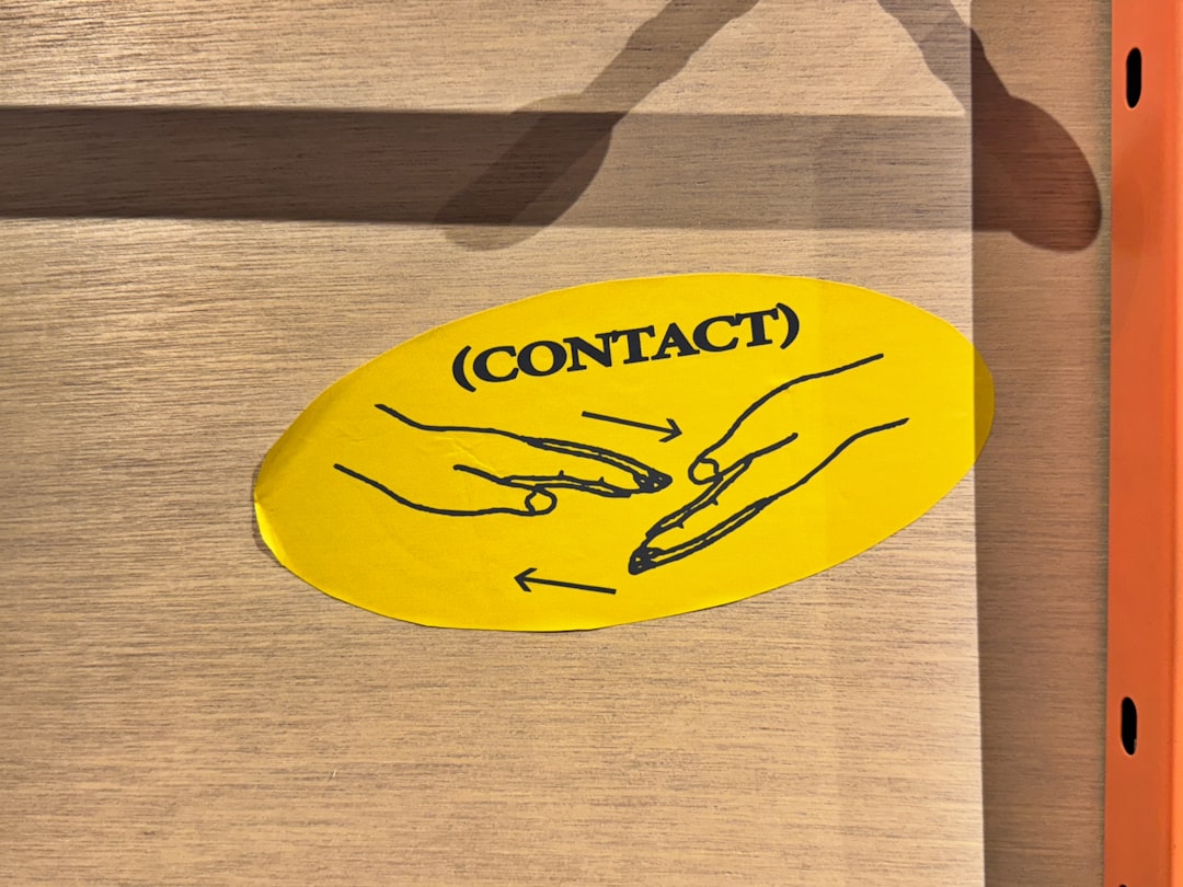 A yellow sticker that says contact on it