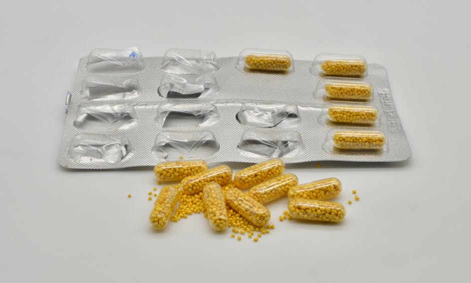Yellow capsules spilling from a blister pack, highlighting pharmaceutical packaging and medication concepts.