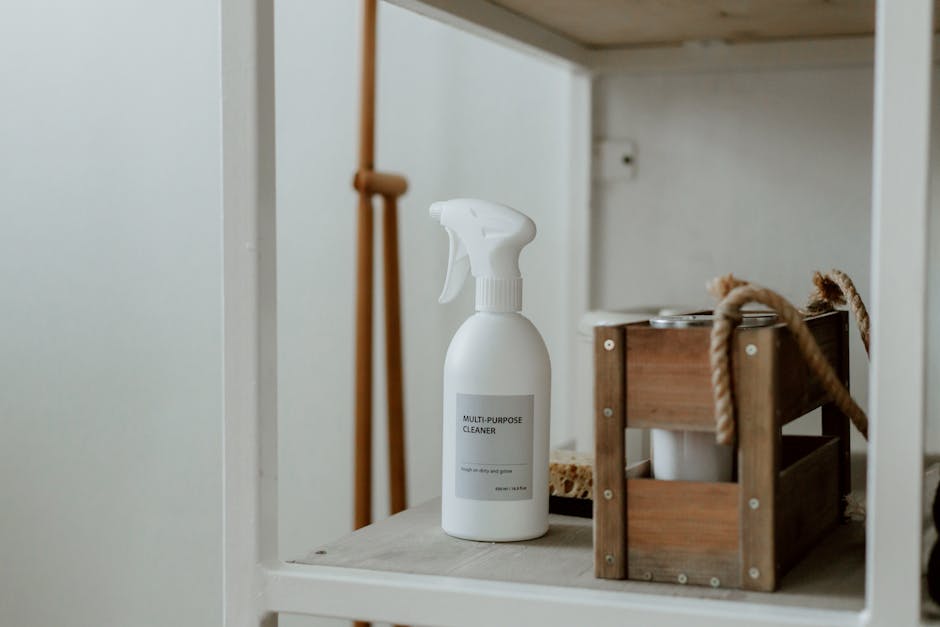 Clean white shelf with a spray cleaner and wooden caddy, perfect for home organization.