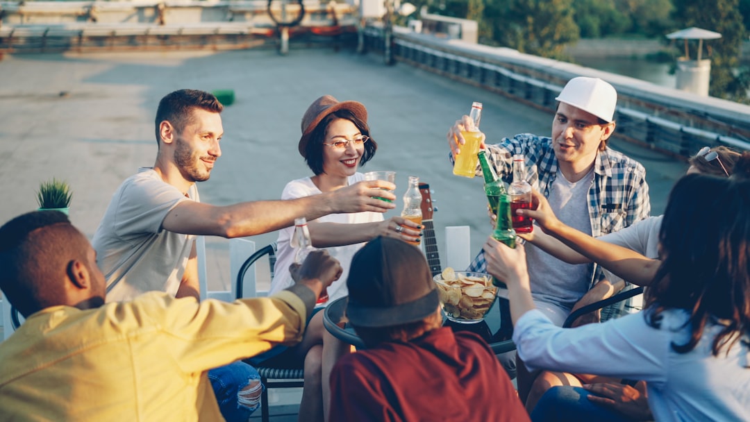 Friends enjoying drinks on a rooftop at sunset