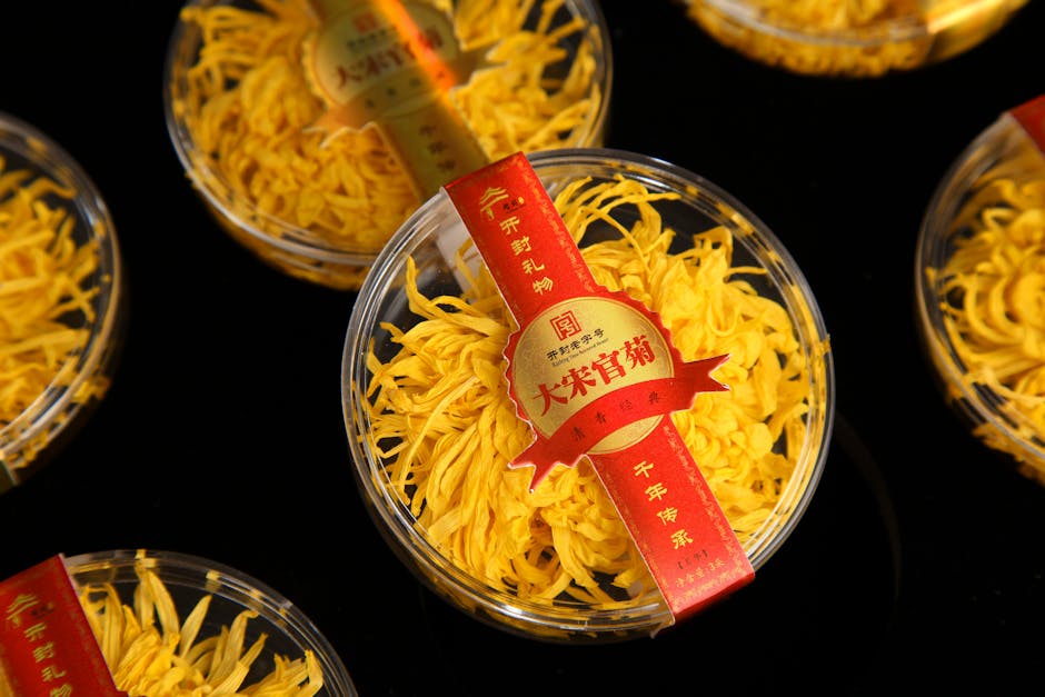 Packaged yellow chrysanthemum flowers on black background.